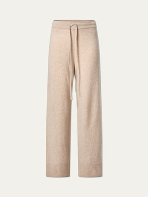 The We Norwegians Geilo Jogger women’s pants feature a beige cozy knit, drawstring waist, ribbed cuffs, and relaxed fit jogger style, shown on a plain light background.