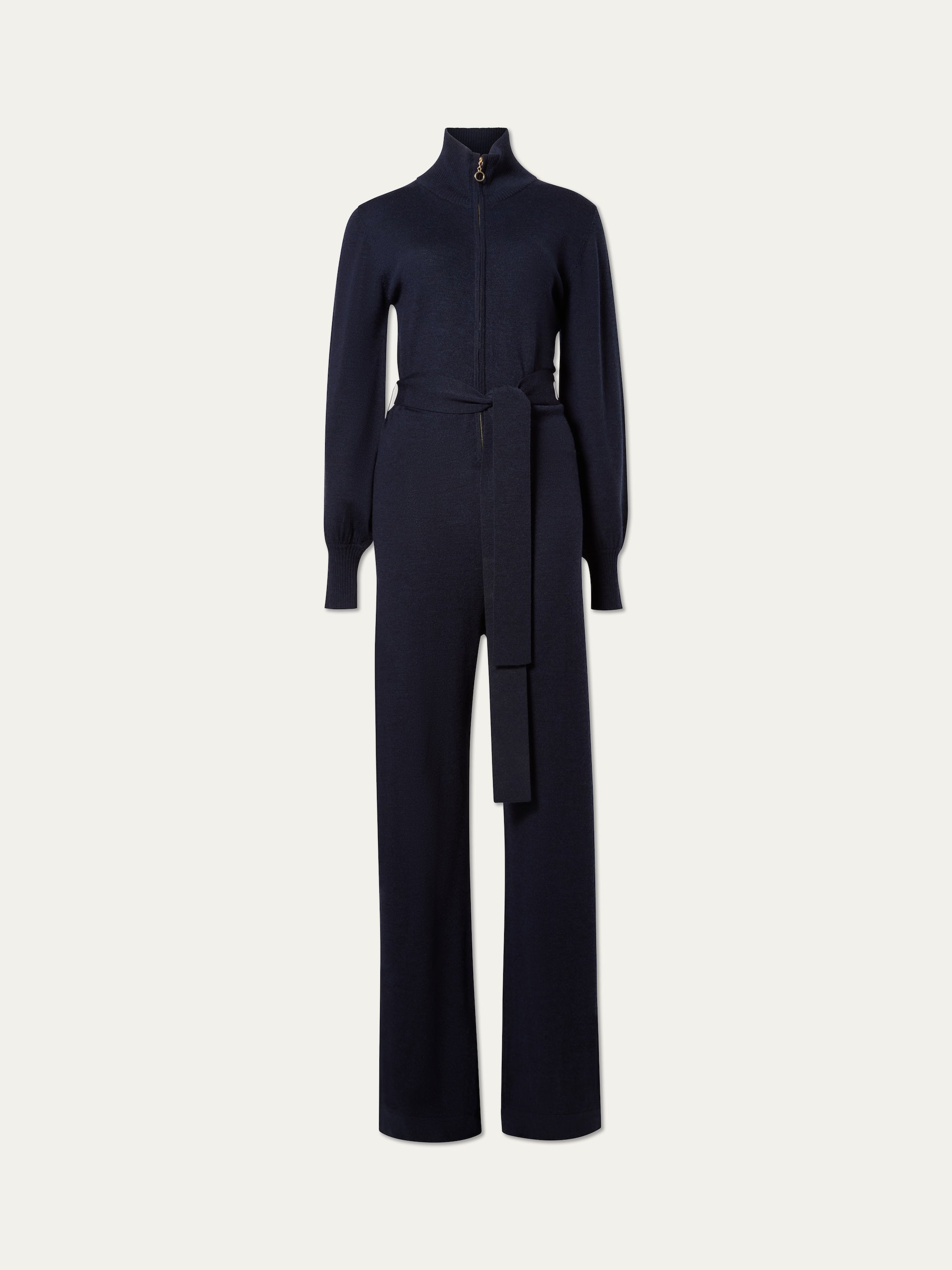 The We Norwegians Geilo Jumpsuit women in navy features a high collar, front zipper, belted waist, and wide-leg pants—ideal for a chic mountain resort look—shown on a plain white background.