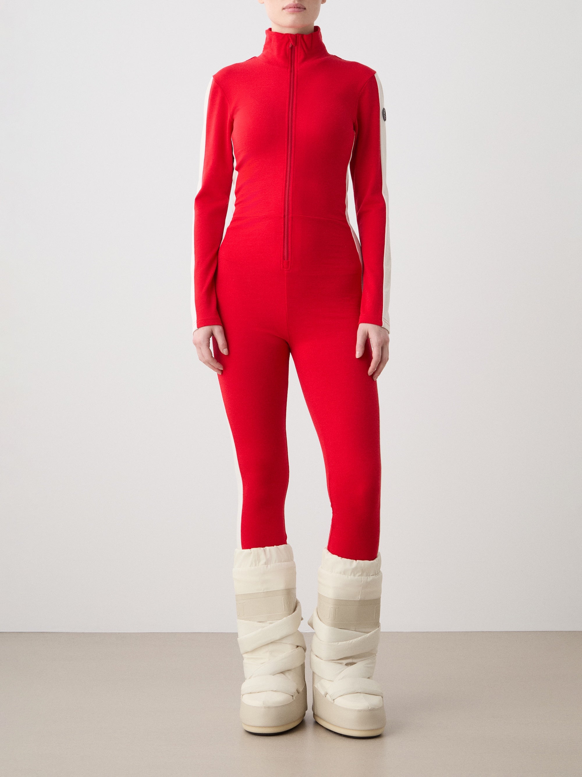 A woman wearing the We Norwegians Voss Jumpsuit in red.