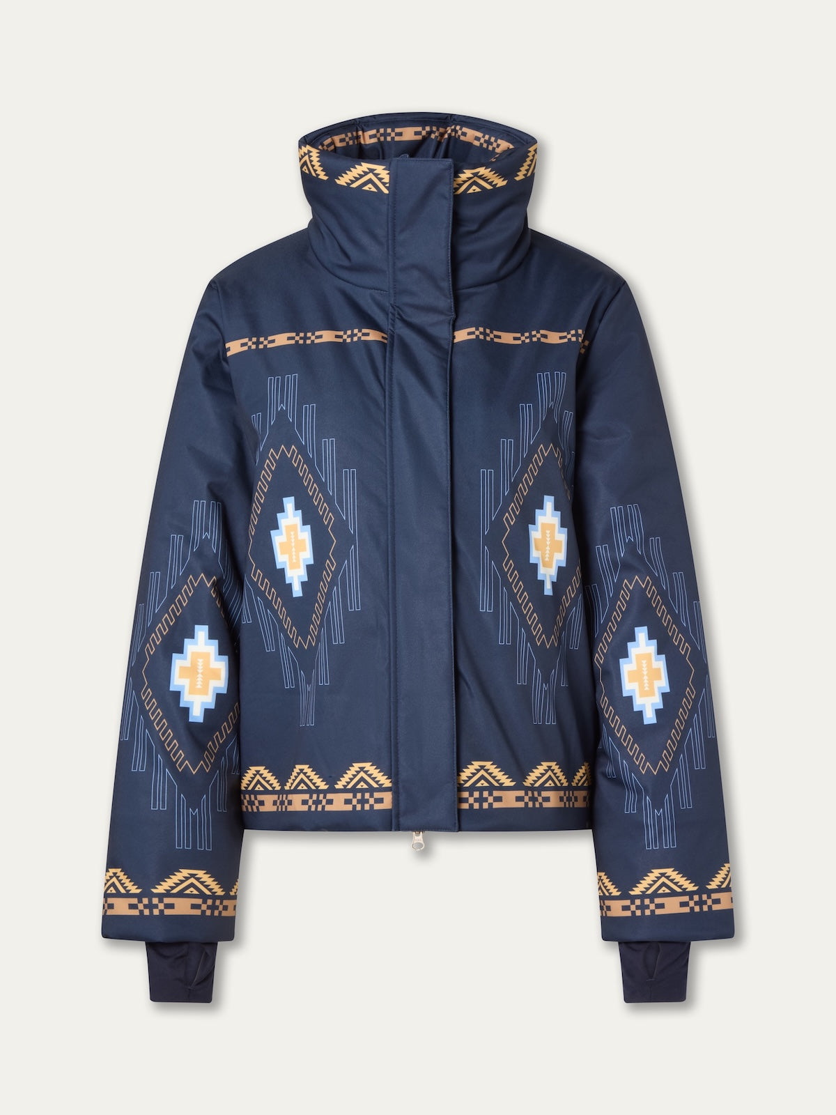The We Norwegians Pioneer Ski Jacket for women is navy blue with geometric patterns in yellow, white, and blue, featuring a high collar and front zipper, inspired by Native American ski jacket designs.