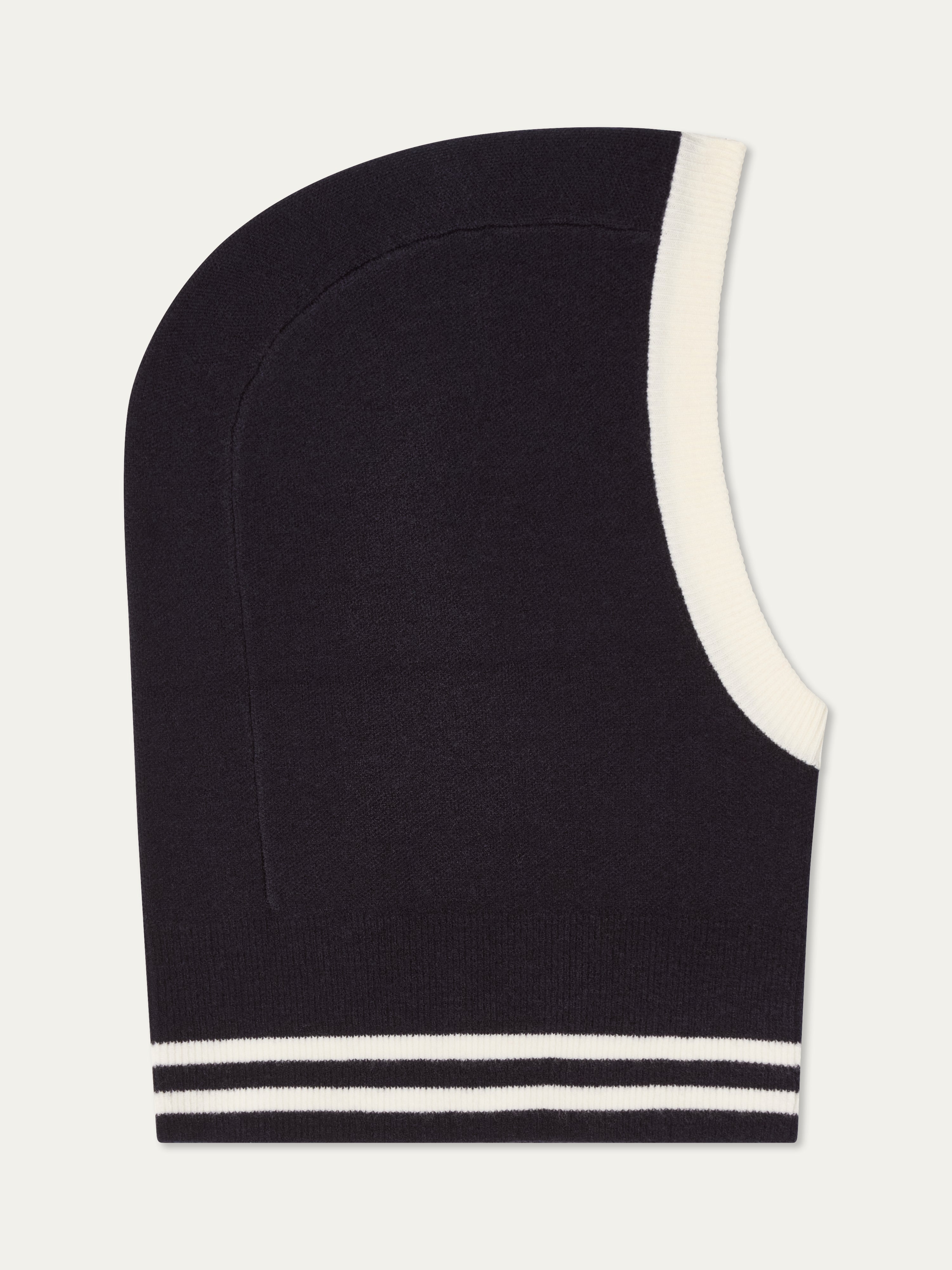 The We Norwegians Rocky Balaclava is a black Merino wool accessory with white trim around the face and two white stripes near the bottom, shown against a plain white background—ideal for winter warmth.