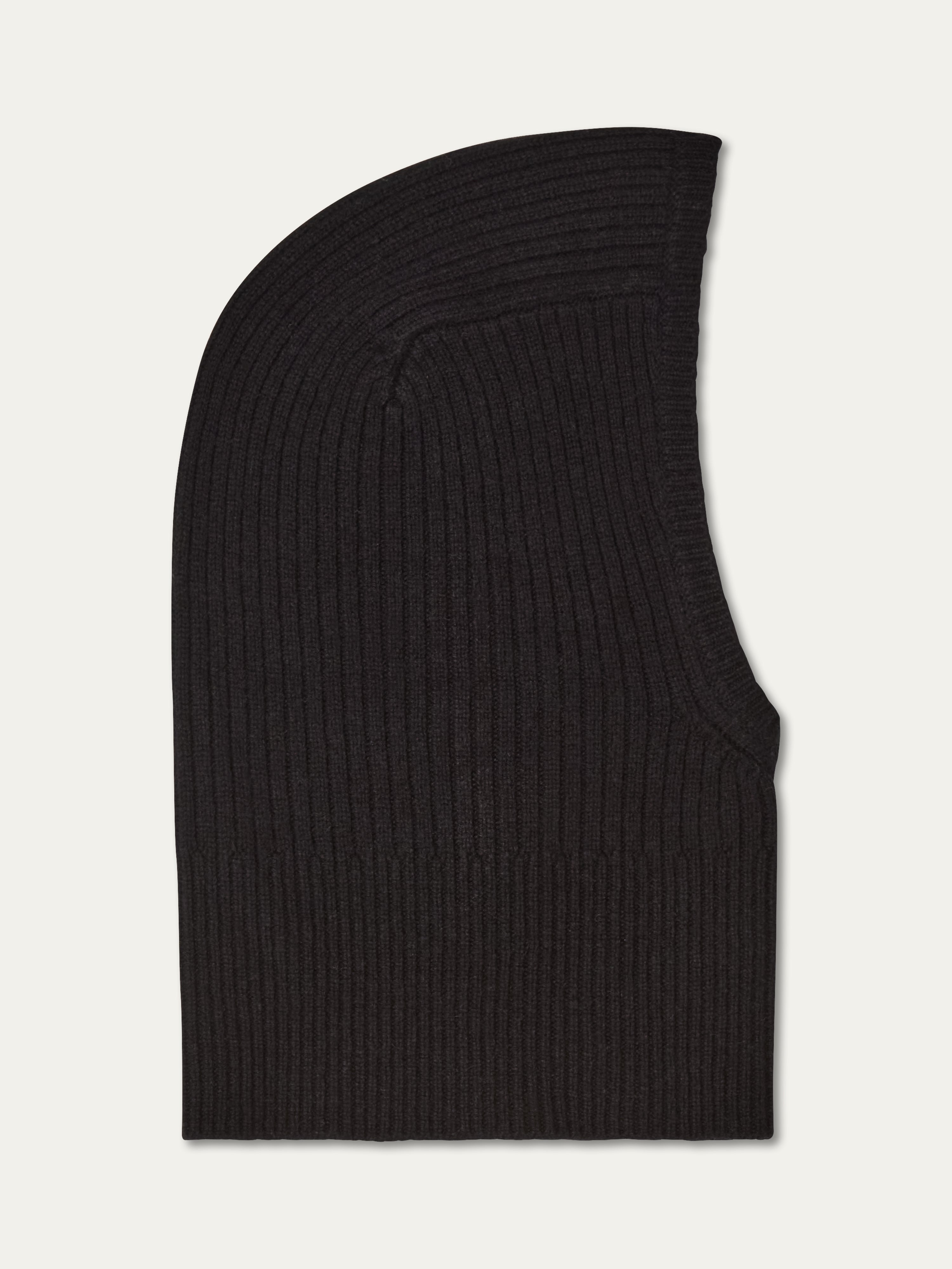The We Norwegians Dal Balaclava, crafted from black Merino wool with a ribbed knit, is displayed flat on a white background, highlighting its hood-like shape and face opening—ideal for Scandinavian winter wear.