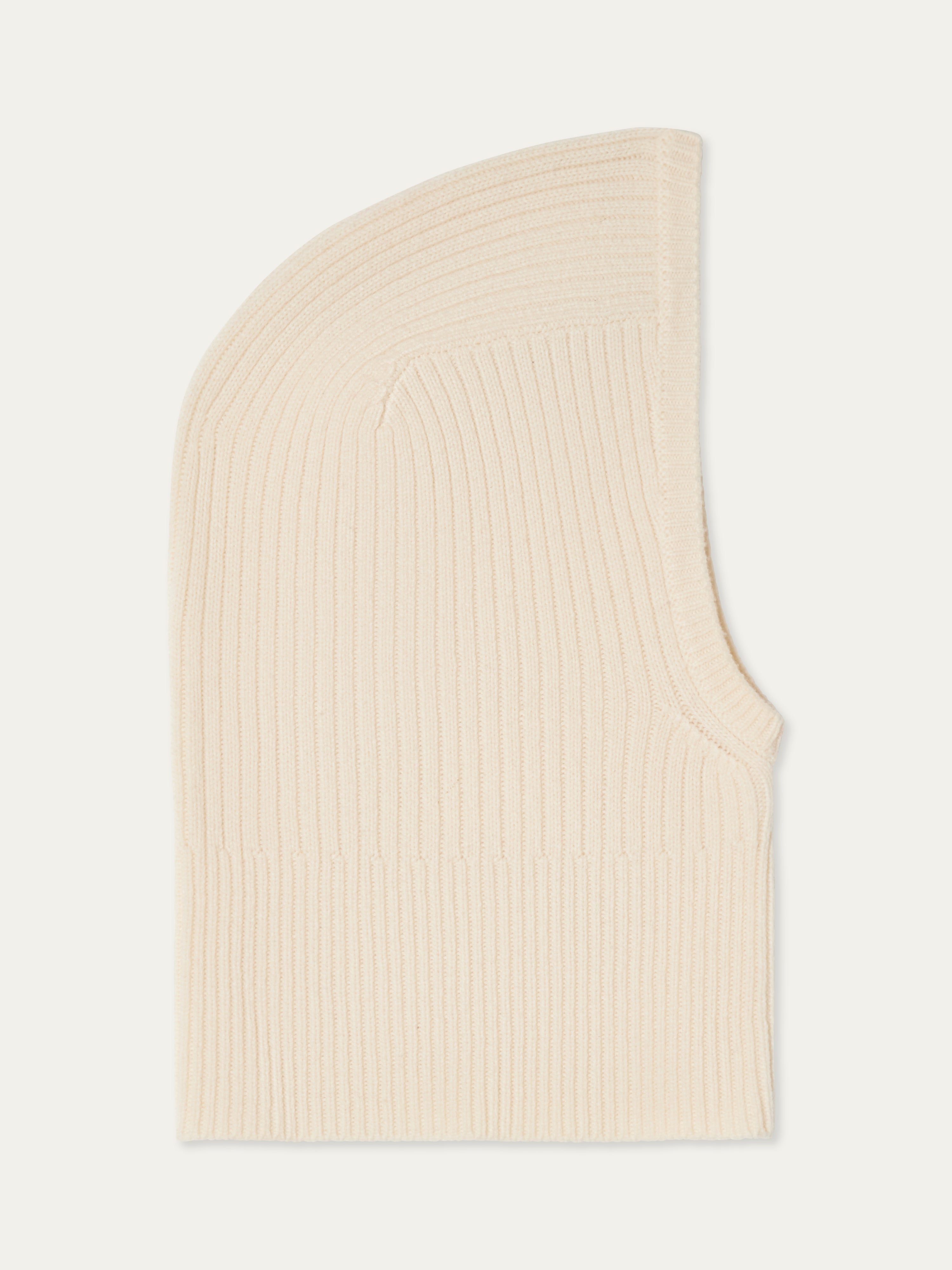 The We Norwegians Dal Balaclava is a cream-colored, ribbed knit Merino wool hood shown flat on a white background, drawing inspiration from classic Scandinavian winter wear.