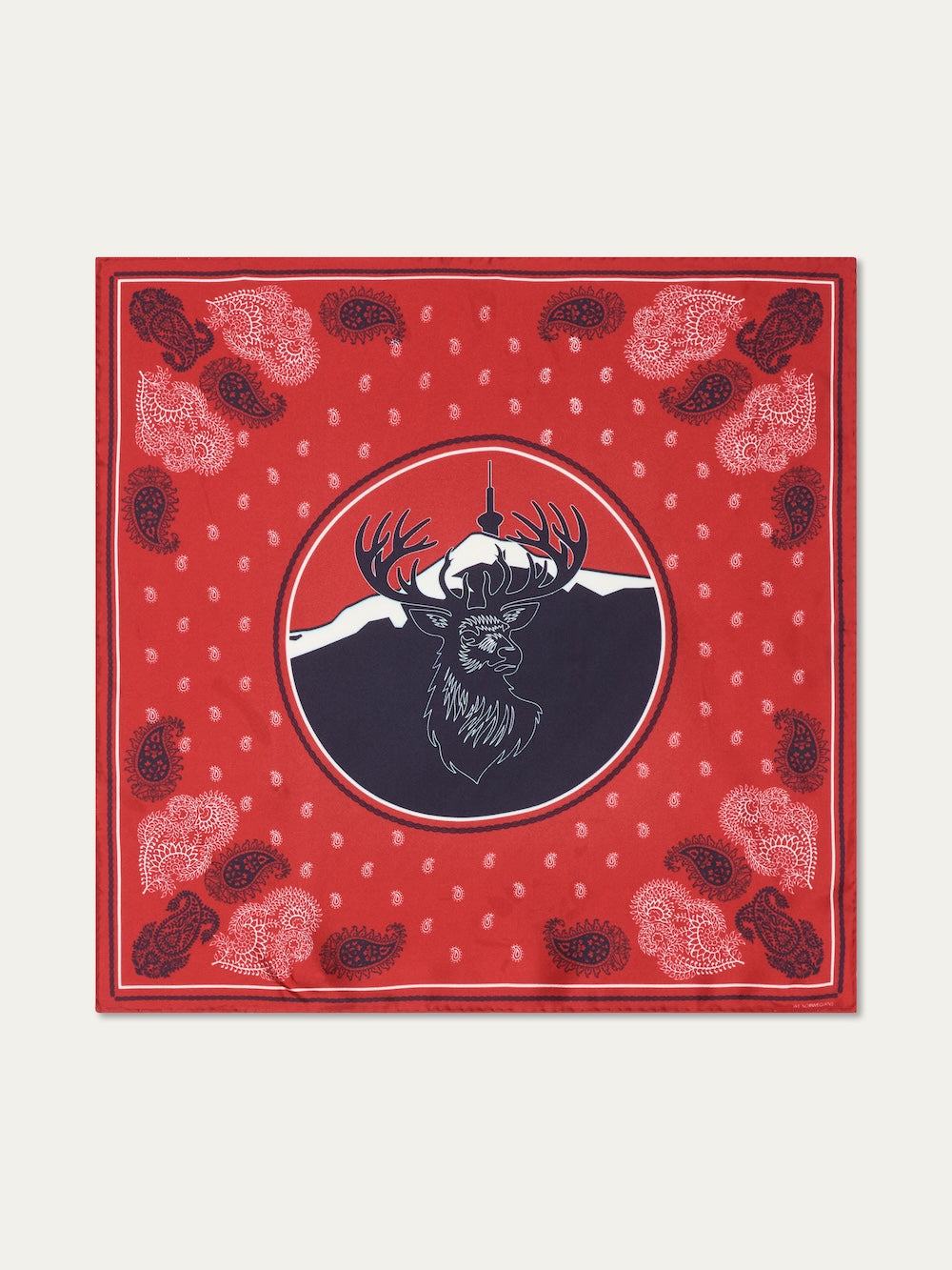 The We Norwegians Western Silk Scarf features a red design with a central deer and antlers before a mountain and tower, accented by paisley patterns and dotted borders, inspired by Norwegian heritage.