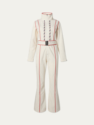 The WN x Markarian Ski Jumpsuit by We Norwegians is a cream long-sleeve, vintage-inspired suit with red piping, high collar, belted waist, flared legs, and floral embroidery—part of the limited edition collaborative collection.