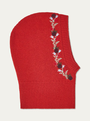 The WN x Markarian Balaclava women by We Norwegians is a limited edition red knit wool piece with ribbed edging and floral embroidery in black and red, plus white and green leaves along one side.