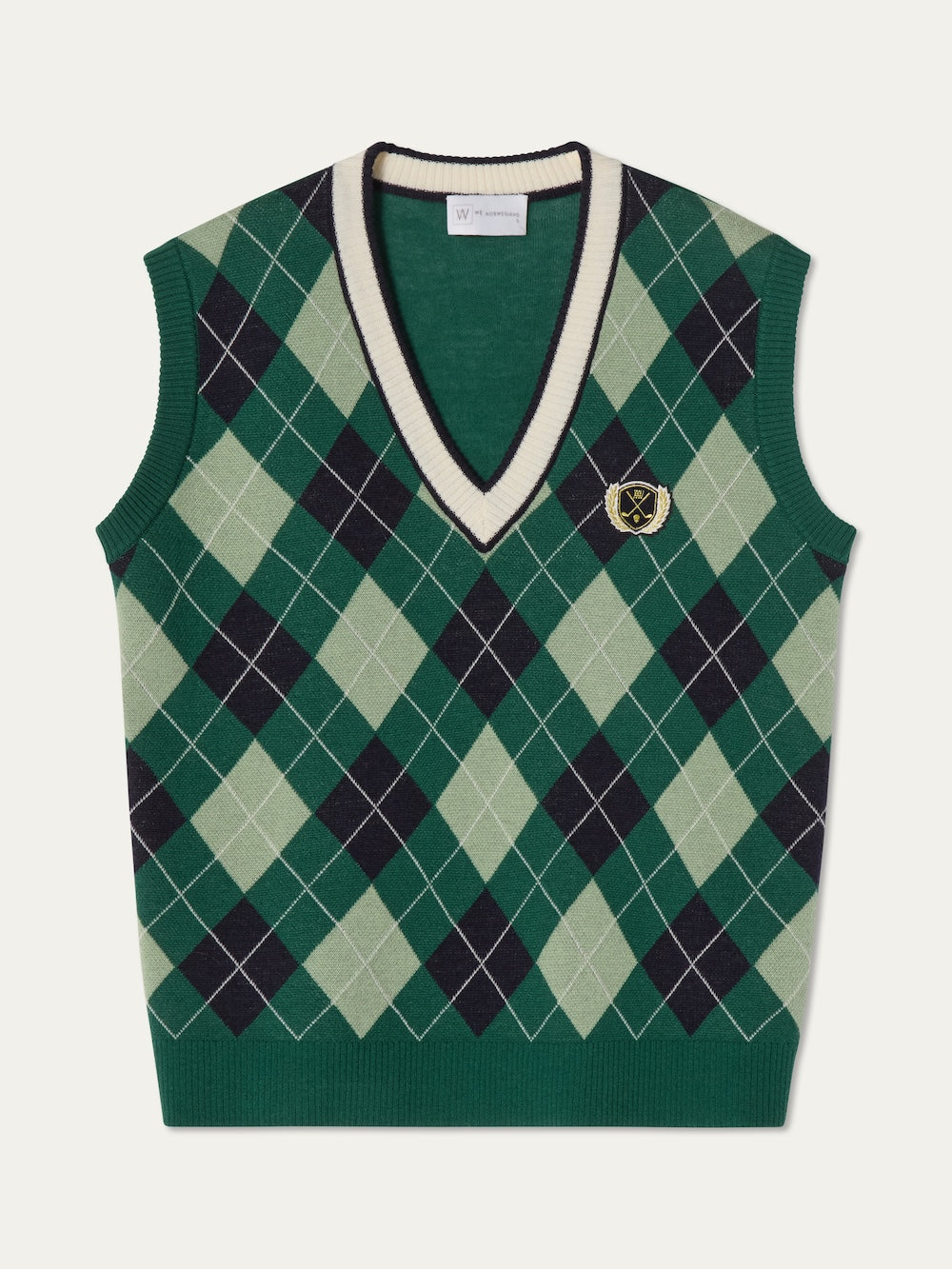 The We Norwegians Fairway Vest Women features a sleeveless green argyle knit design with dark and light green diamonds, a white and green striped V-neck, and a small embroidered crest—perfect as a stylish golf vest.