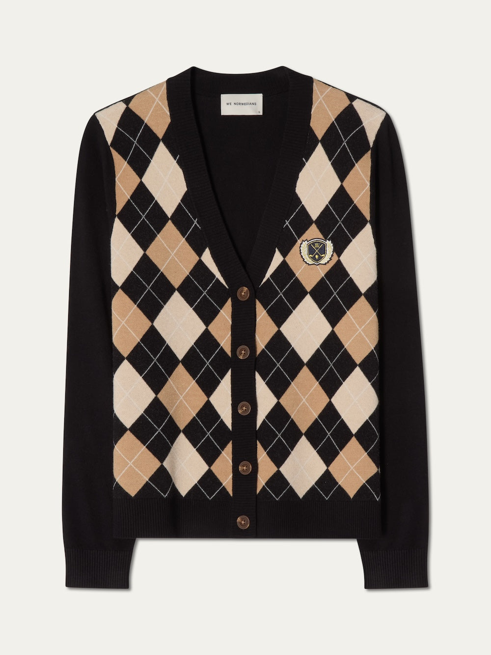 The Fairway Cardigan Women by We Norwegians is a black argyle knit sweater with brown, beige, and white patterns, brown buttons, and a small embroidered crest—an elegant choice for any occasion.