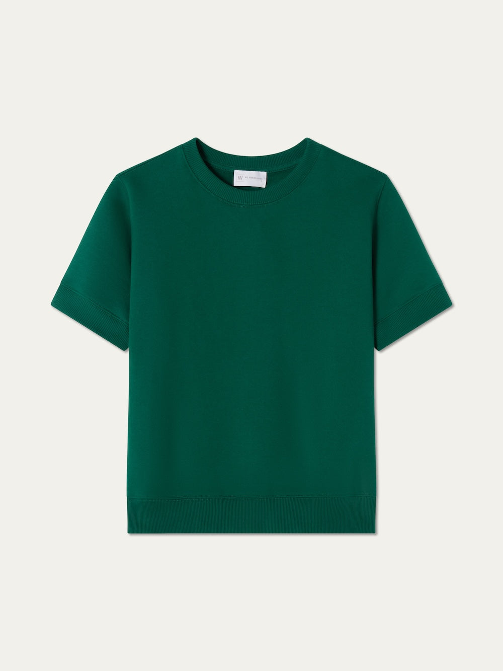 The We Norwegians Bounce Top Women is a short-sleeved, crew neck cotton sweatshirt in solid emerald green, shown laid flat against a light background.