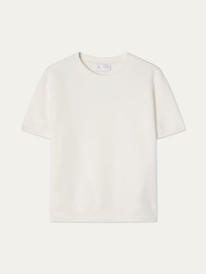 The We Norwegians Bounce Top Women is a plain white, sporty short-sleeve crew neck displayed against a light background. Its simple, logo-free cotton design offers timeless versatility.