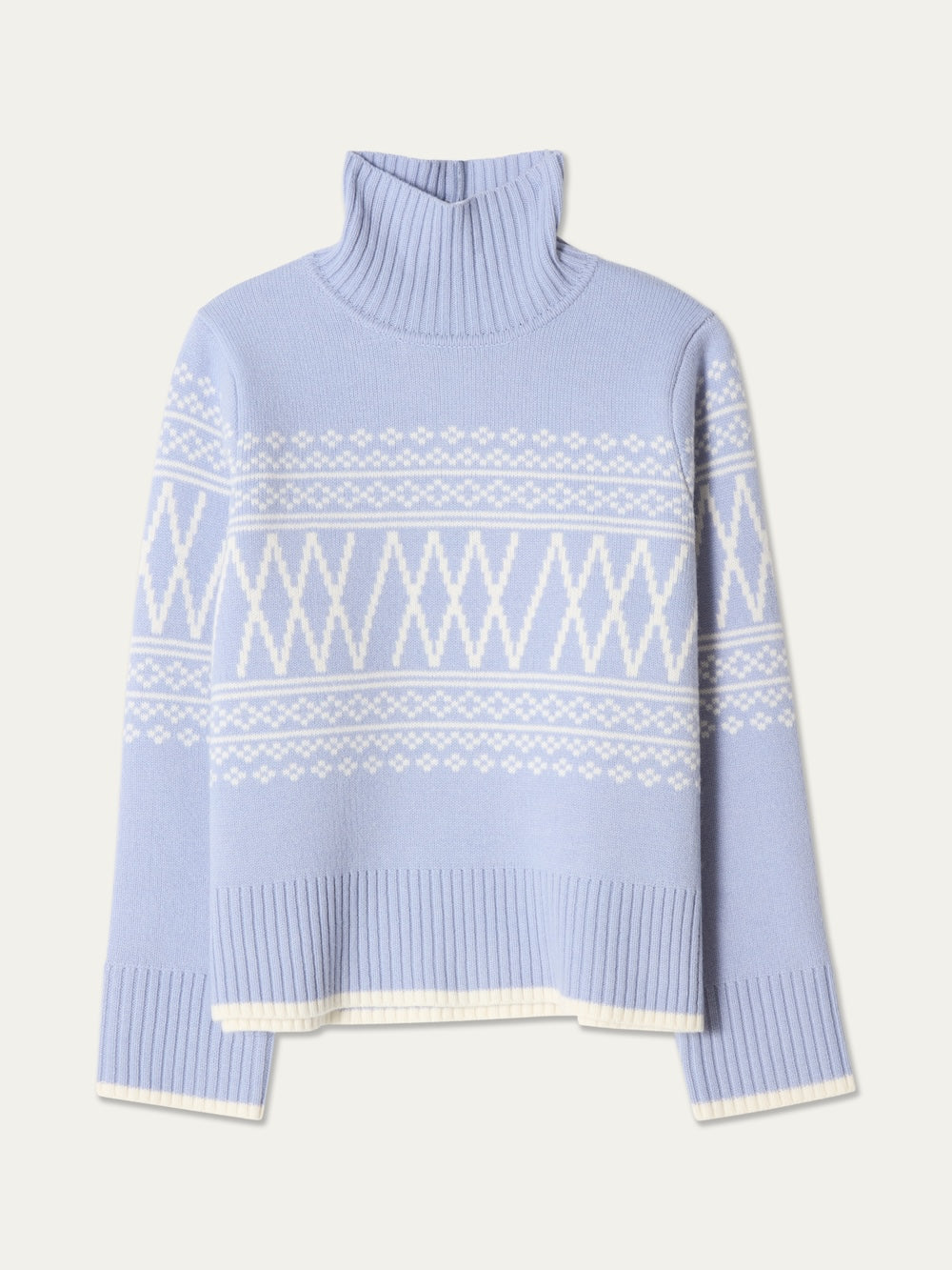 The We Norwegians Setesdal Pullover women’s sweater in light blue showcases classic Norwegian knit motifs with white geometric and diamond patterns. Designed with a ribbed turtleneck, cuffs, and hem, this style is presented laid flat on a plain background.