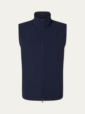 The We Norwegians Albatross Vest Men is a sleeveless, navy blue lightweight golf vest featuring a high collar, minimalistic design, and a subtle embroidered logo on the left chest, shown against a plain white background.
