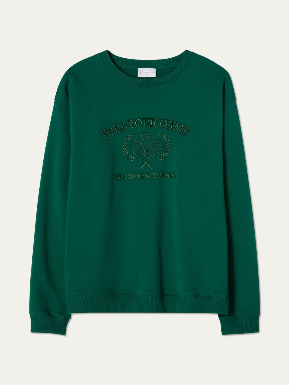 The We Norwegians Bounce Sweater Men is a green velour crewneck with ribbed cuffs and hem, embroidered "FUEL YOUR GAME" and "WE NORWEGIANS" plus a tennis racket and laurel wreath for vintage tennis style.