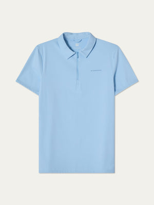 The We Norwegians Honor Zipped Polo Men is a light blue, short-sleeve performance polo with a collar and front zip. Subtle chest text. Made from high-performance fabric, perfect for active days or as a golf polo. Displayed flat on a plain background.