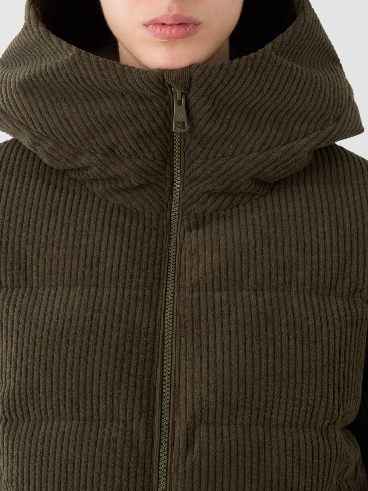 A person models the We Norwegians Britt Ski Jacket Women—cropped to show only the lower face and upper torso—highlighting the cozy, sustainable style of this ski essential.