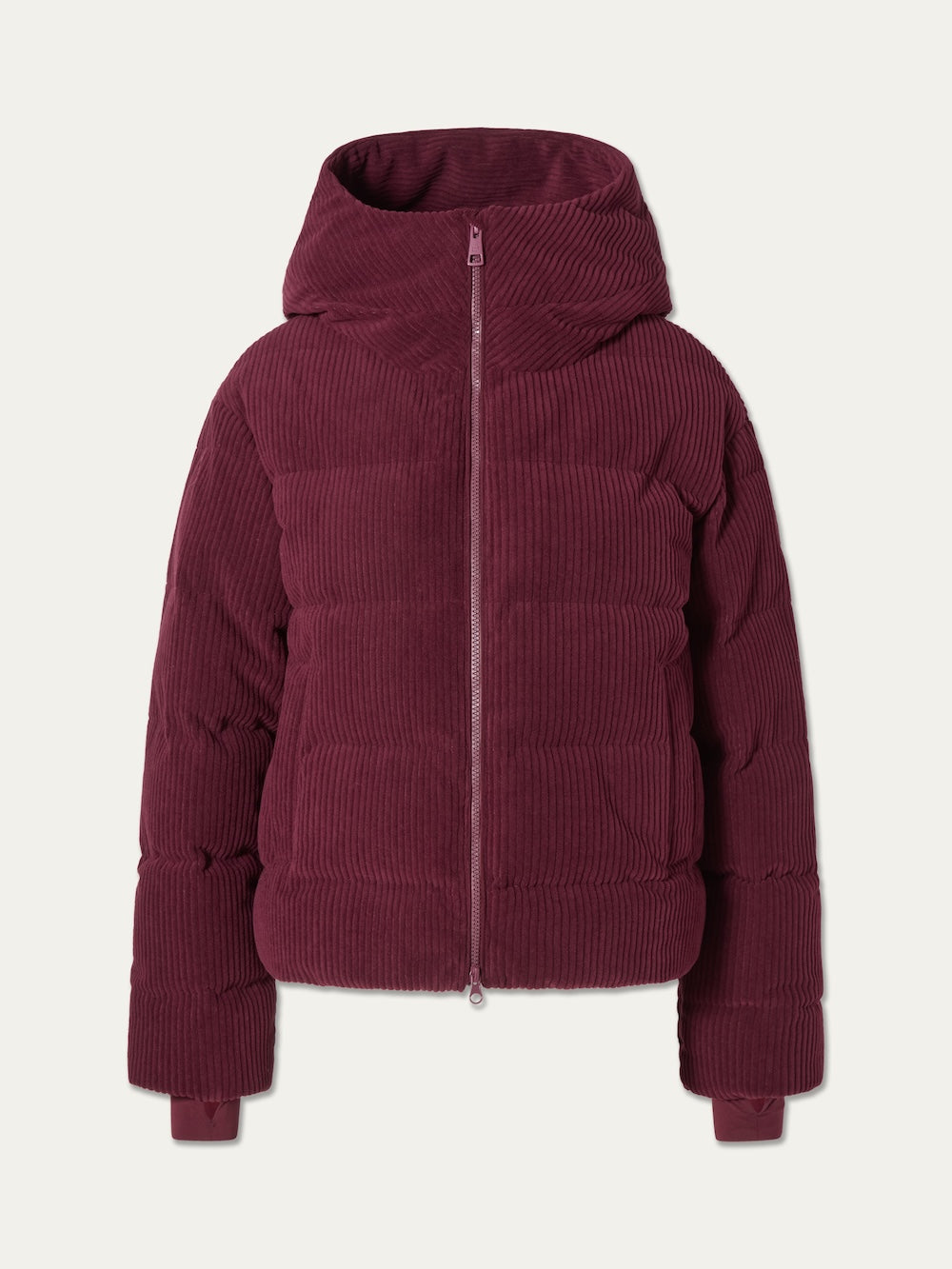 The Britt Ski Jacket Women by We Norwegians, in burgundy corduroy with a front zipper, hood, and ribbed texture, is displayed on a plain white background—stylish and cozy.
