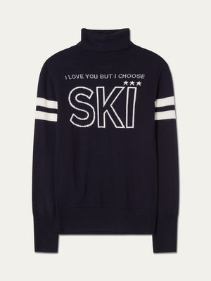 Introducing the Bibi Fitted Sweater Women by We Norwegians—a navy blue turtleneck sweater featuring white stripes on the sleeves and “I LOVE YOU BUT I CHOOSE SKI” printed in bold white text on the front. Effortlessly blending retro ski style with modern comfort, this stylish and cozy piece is perfect for après-ski or elevating your everyday look.
