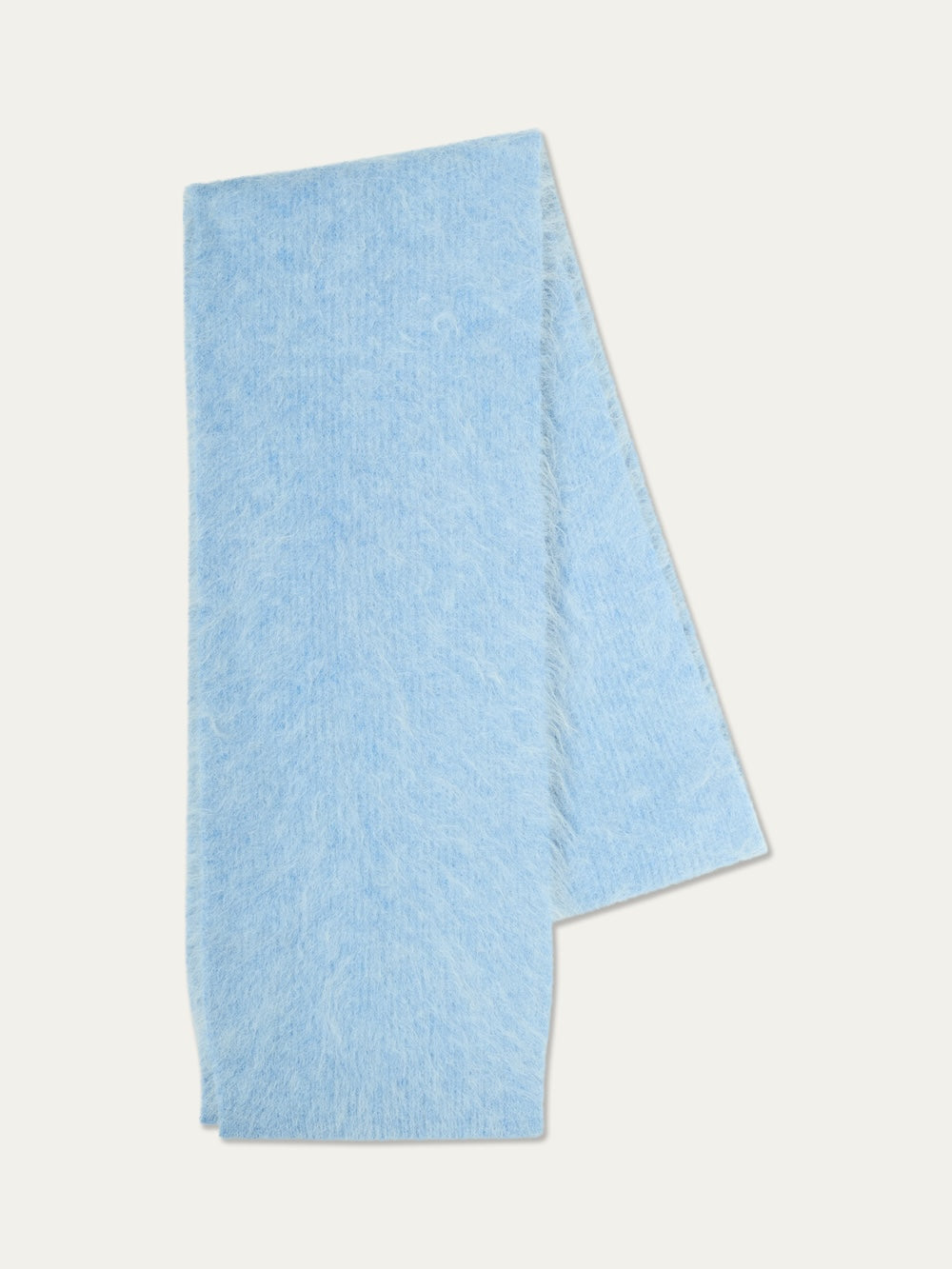 The Myrull Scarf by We Norwegians, in a soft, light blue alpaca blend with a fuzzy texture and Nordic-inspired elegance, is neatly folded on a plain white background.