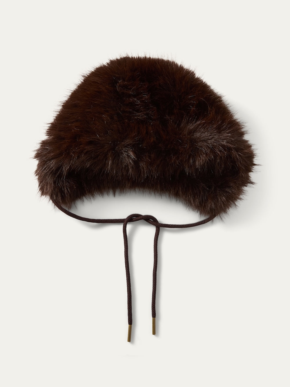 The We Norwegians Dovre Bonnet is a dark brown faux fur hat with a rounded shape and two slim brown tie strings, inspired by classic retro styles.