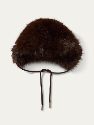 The We Norwegians Dovre Bonnet is a dark brown faux fur hat with a rounded shape and two slim brown tie strings, inspired by classic retro styles.
