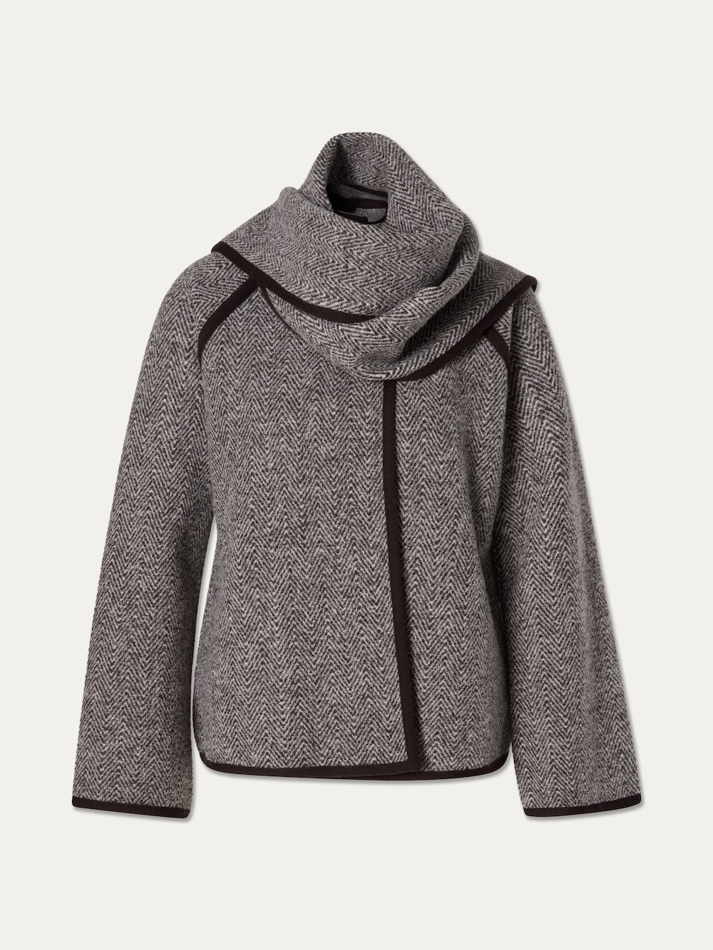 The Laerdal Boiled Wool Cape Women by We Norwegians features a gray herringbone pattern, a wide asymmetrical shawl collar, and dark trim outlining the edges, showcased against a plain light backdrop.