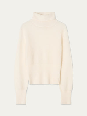The Pudder Sweater Women by We Norwegians is a cream-colored, long-sleeve turtleneck crafted from cozy mohair yarn, featuring ribbed cuffs and hem, and is displayed on a plain light background.