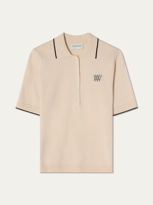 Beige polo shirt with black details on an off white background