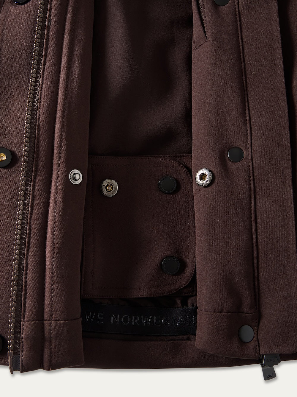 Close-up of the Finse Ski Jacket Women by We Norwegians, showing its inner pocket with snap buttons, detailed stitching, and a zipper edge—crafted for the modern ski jacket enthusiast.