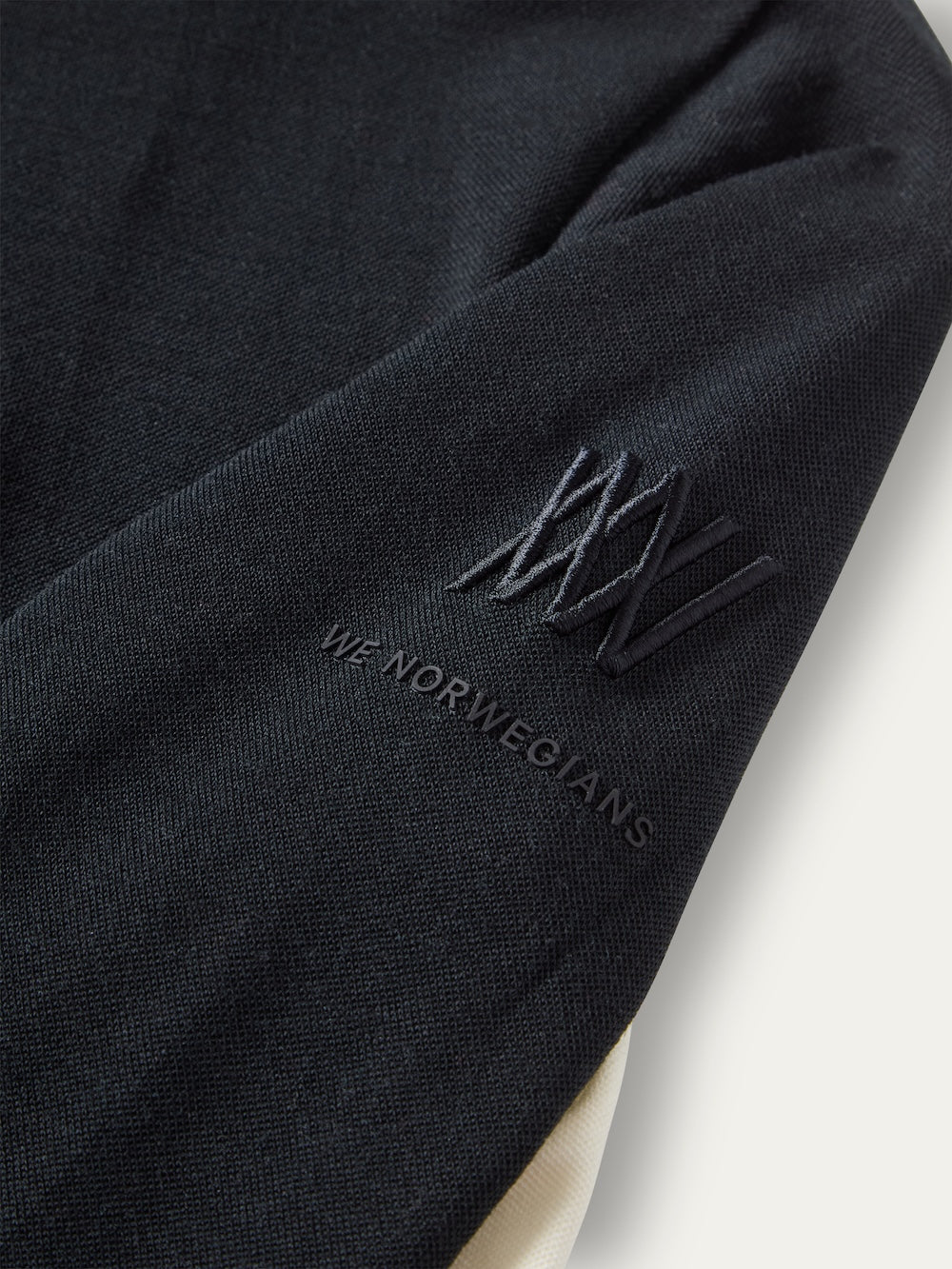 Black Voss ZipUp Women featuring an embroidered logo and brand name on the upper sleeve.