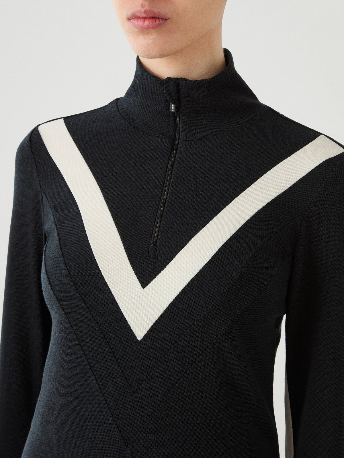 Black Voss Chevron ZipUp Women zip-up top with a high collar and a white chevron pattern across the chest.