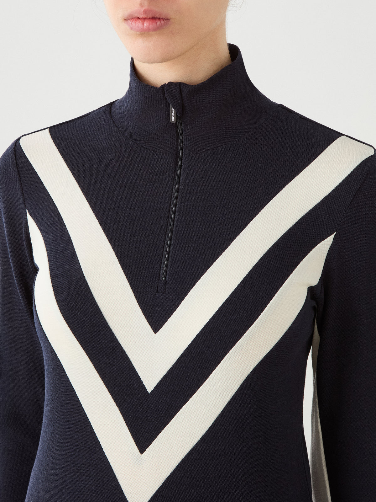 Navy blue Merino wool Voss Chevron ZipUp Women mock-neck top featuring white chevron stripes on the chest.