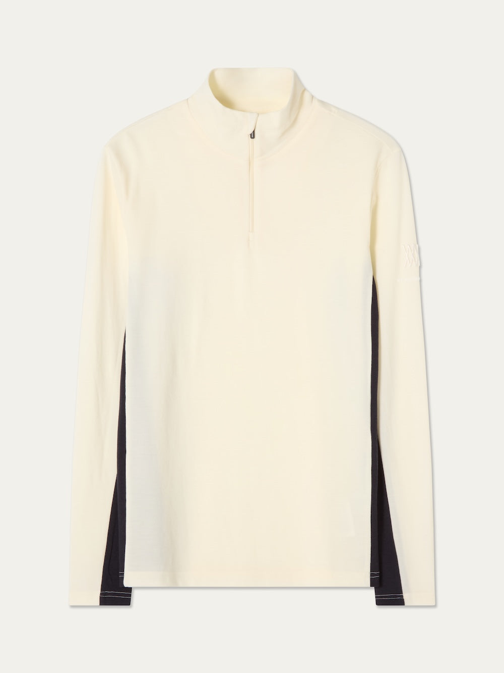 The We Norwegians Voss ZipUp Men is a long-sleeve, off-white quarter-zip ski base layer pullover made from soft merino wool, featuring bold black color block side panels and displayed on a plain background.