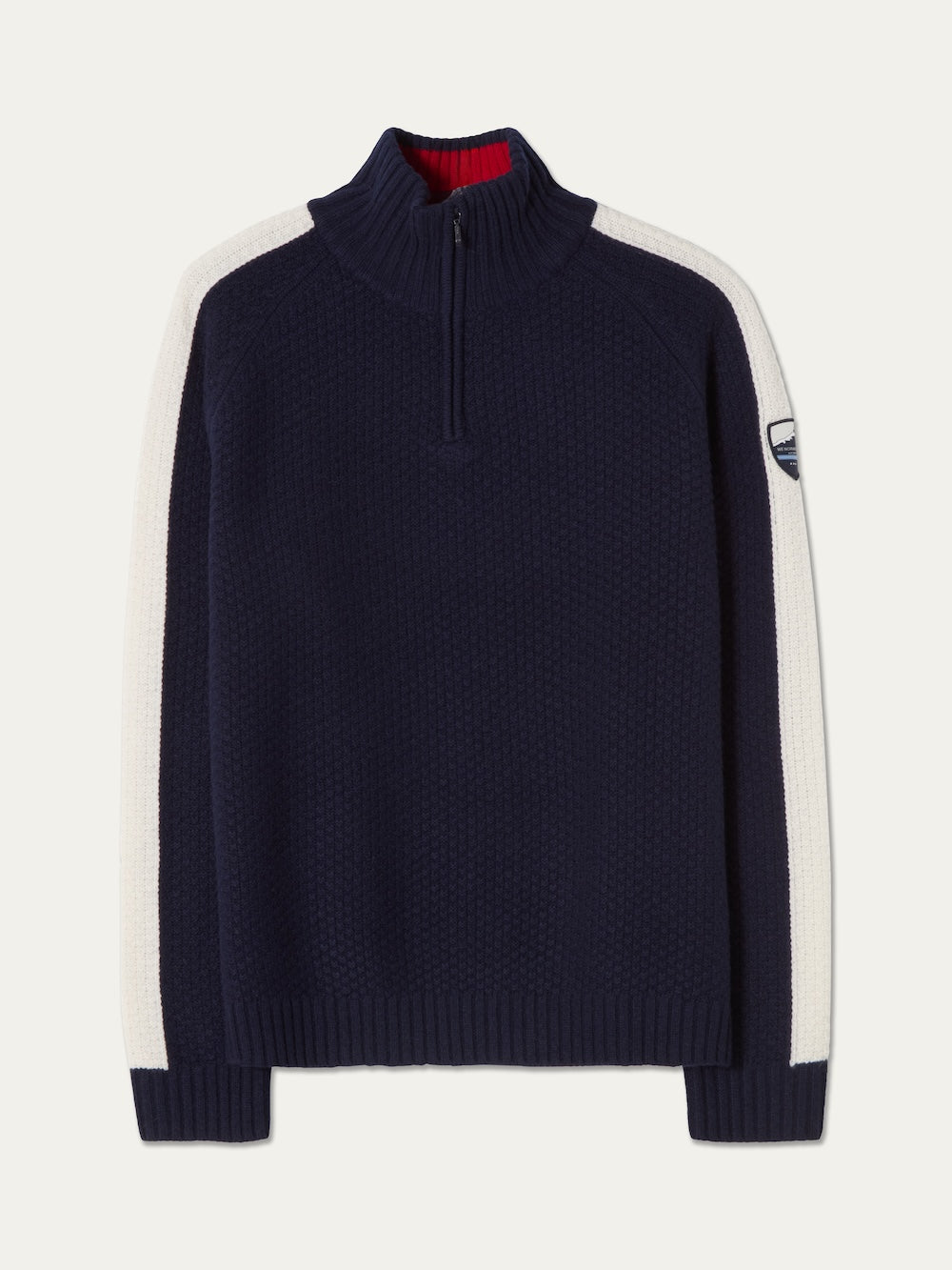 Introducing the We Norwegians Kikut ZipUp Sweater Men—a navy blue pullover inspired by the classic Kikut Sweater, featuring a half-zip collar, white stripes along the sleeves, ribbed cuffs and hem, and a subtle patch on the upper left sleeve. Perfect as an après-ski sweater for brisk mountain evenings.