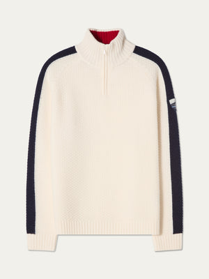 The We Norwegians Kikut ZipUp Sweater Men is a cream-colored sweater made from soft merino wool, featuring a half-zip collar, black stripes down the sleeves, ribbed cuffs and hem, and a small patch on the upper left sleeve—ideal for après-ski comfort on cozy mountain evenings.