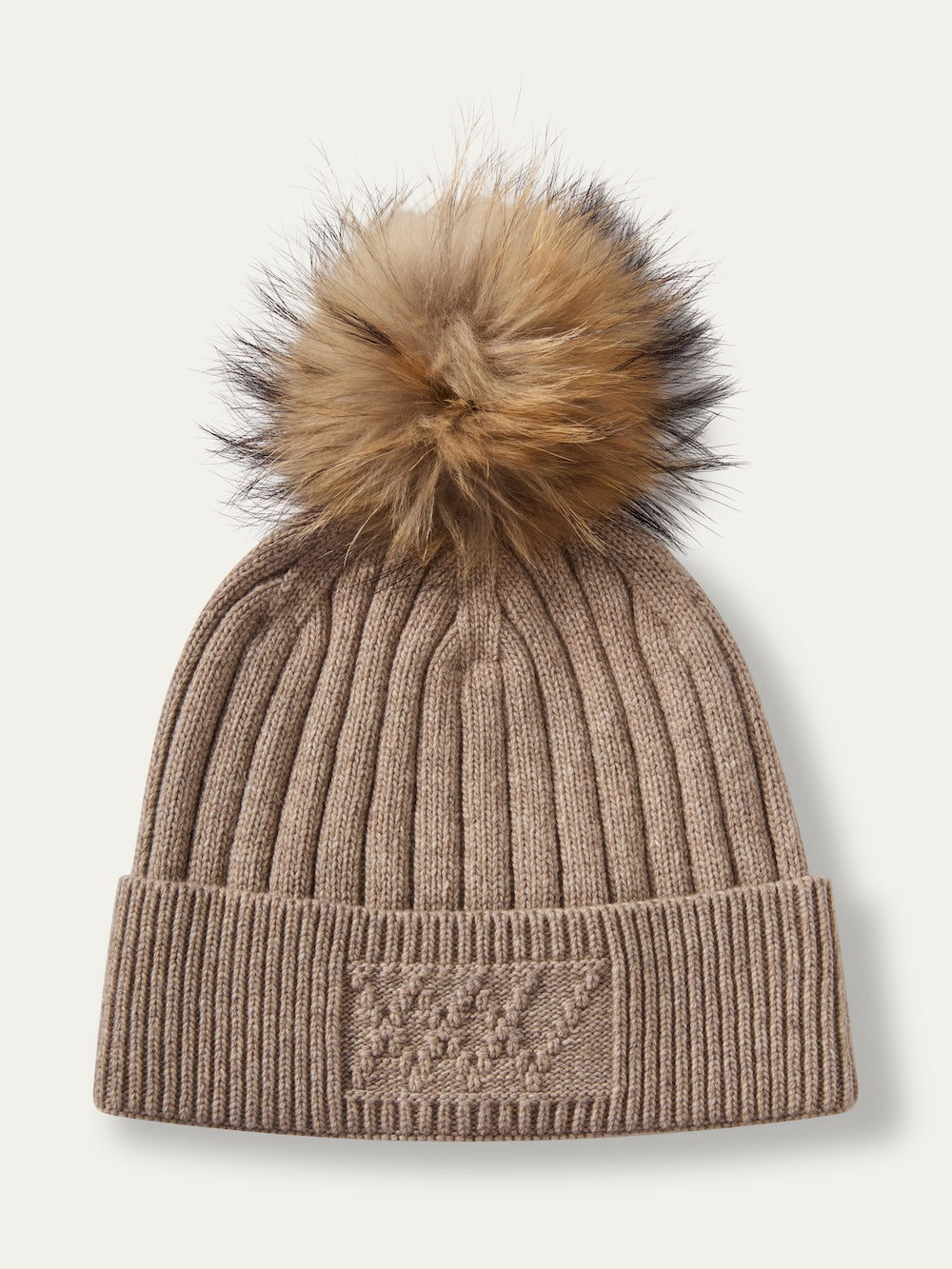 Light brown ribbed knit We Norwegians Geilo PomPom Hat with a large brown and black faux fur pompom and a matching embroidered monogram on the cuff.