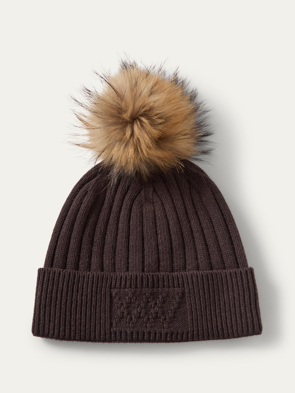 Dark brown ribbed knit Geilo PomPom Hat with a large faux fox fur pom pom on top.