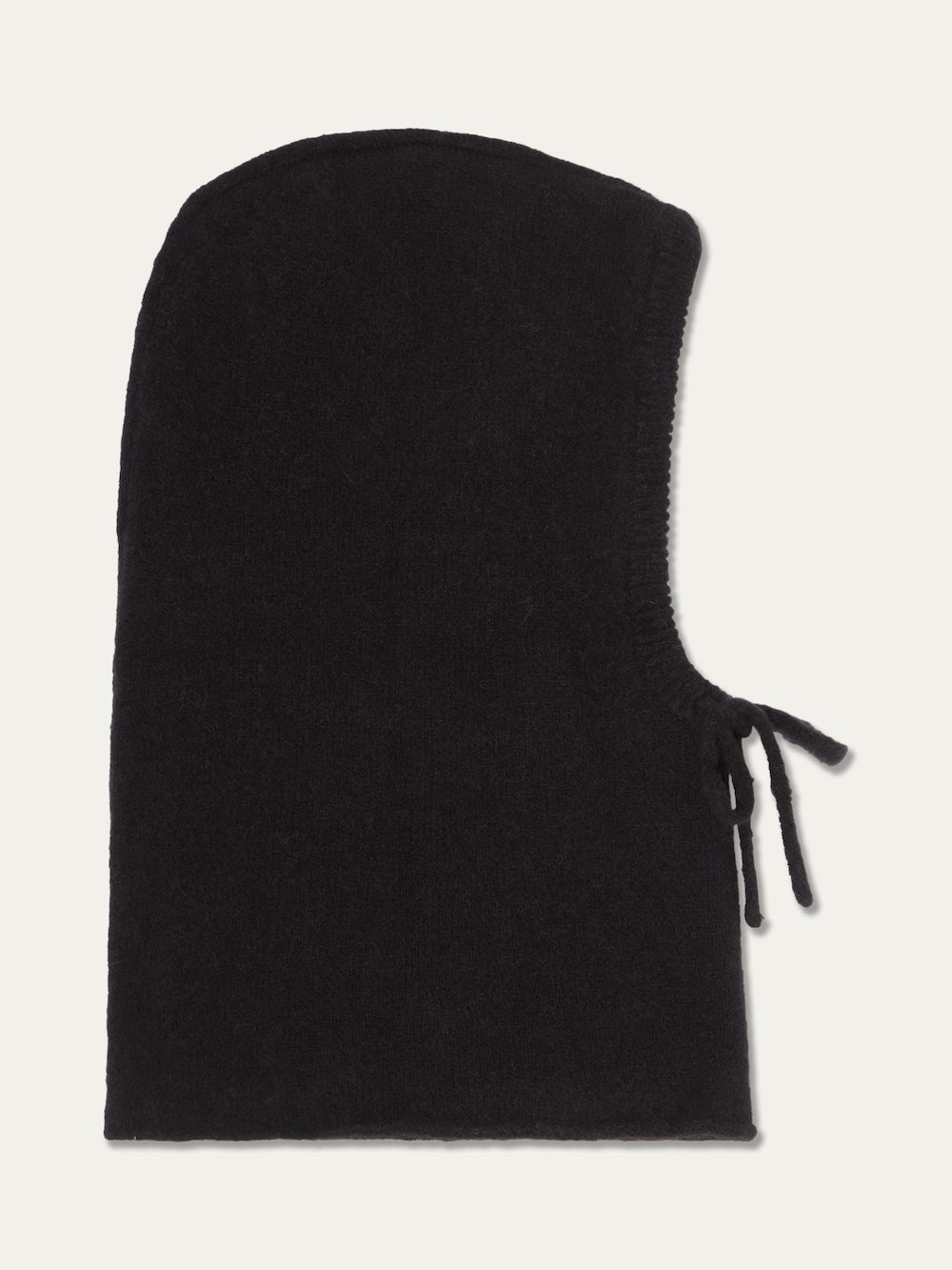 The Norefjell Hood by We Norwegians is a black knit alpaca wool balaclava with a rounded top and an open face, featuring two drawstring ties on the right side. Cosy and practical, this winter accessory is displayed against a plain off-white background.