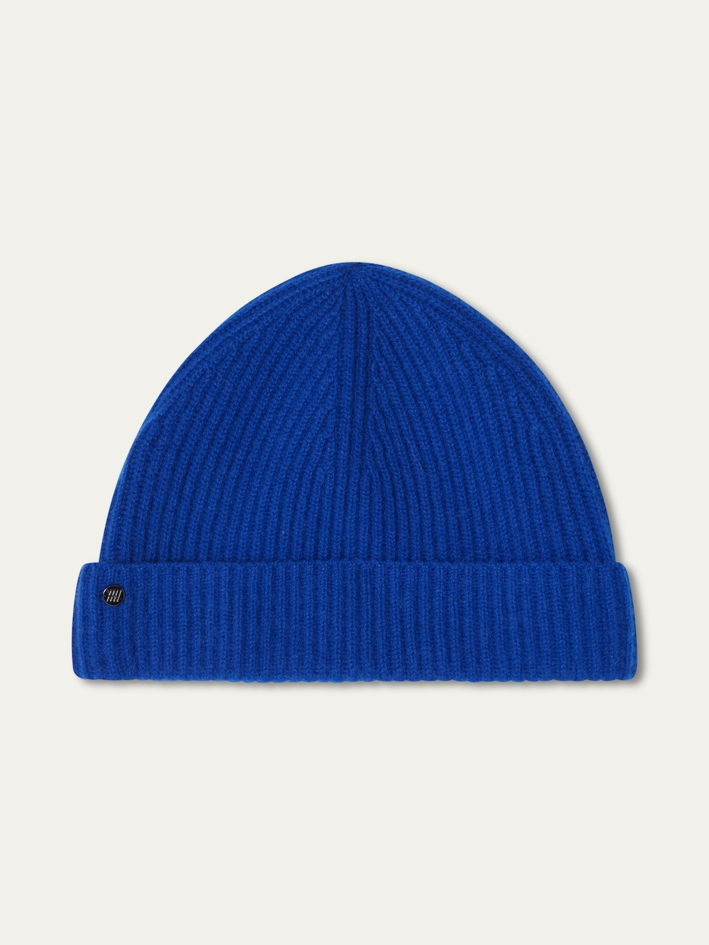 The Blefjell Hat For All by We Norwegians is a bright blue, ribbed knit pure cashmere hat with a folded brim and a small black rectangular tag. Displayed flat on a light background, this classic accessory is one size fits most.