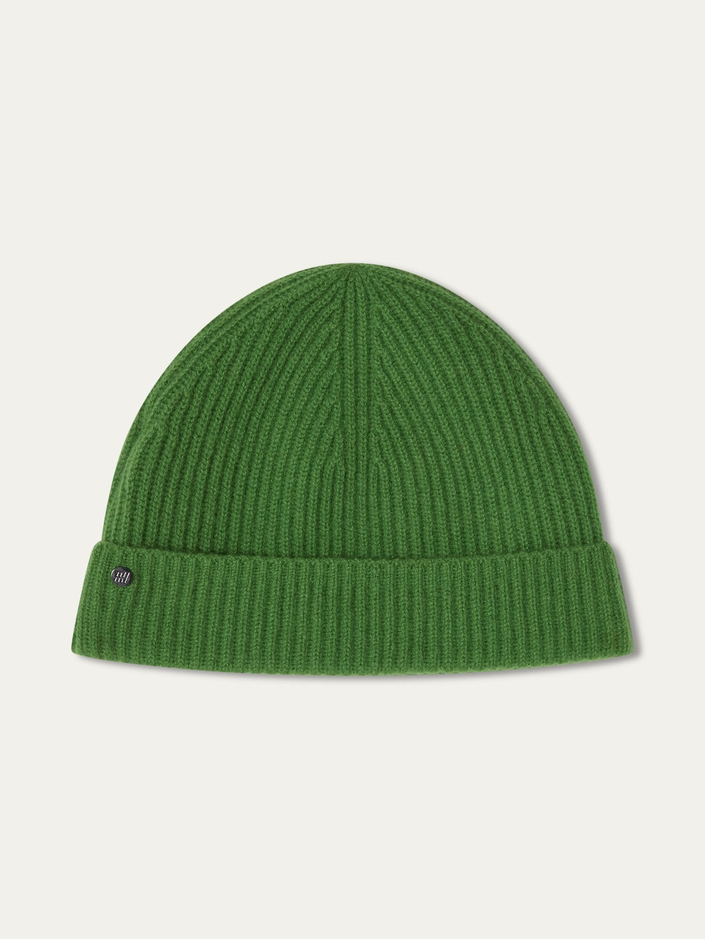 The We Norwegians Blefjell Hat For All is a green ribbed knit beanie in pure cashmere, featuring a folded cuff and a small round metal tag on the left. One size fits most. Displayed on a plain light background.