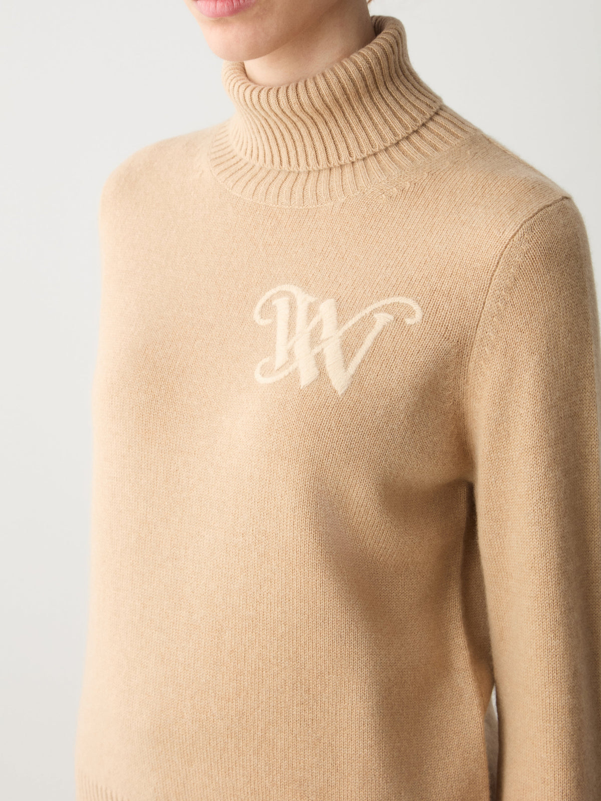Tan We Norwegians Monogram Cashmere Sweater Women featuring a cream-colored monogram logo on the chest.