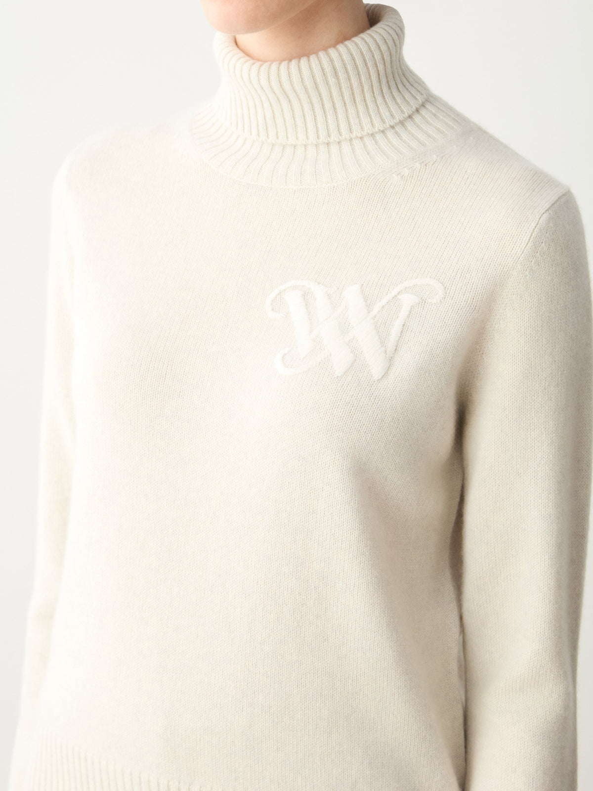 Cream We Norwegians Monogram Cashmere Sweater Women turtleneck sweater featuring a tonal embroidered monogram on the chest.