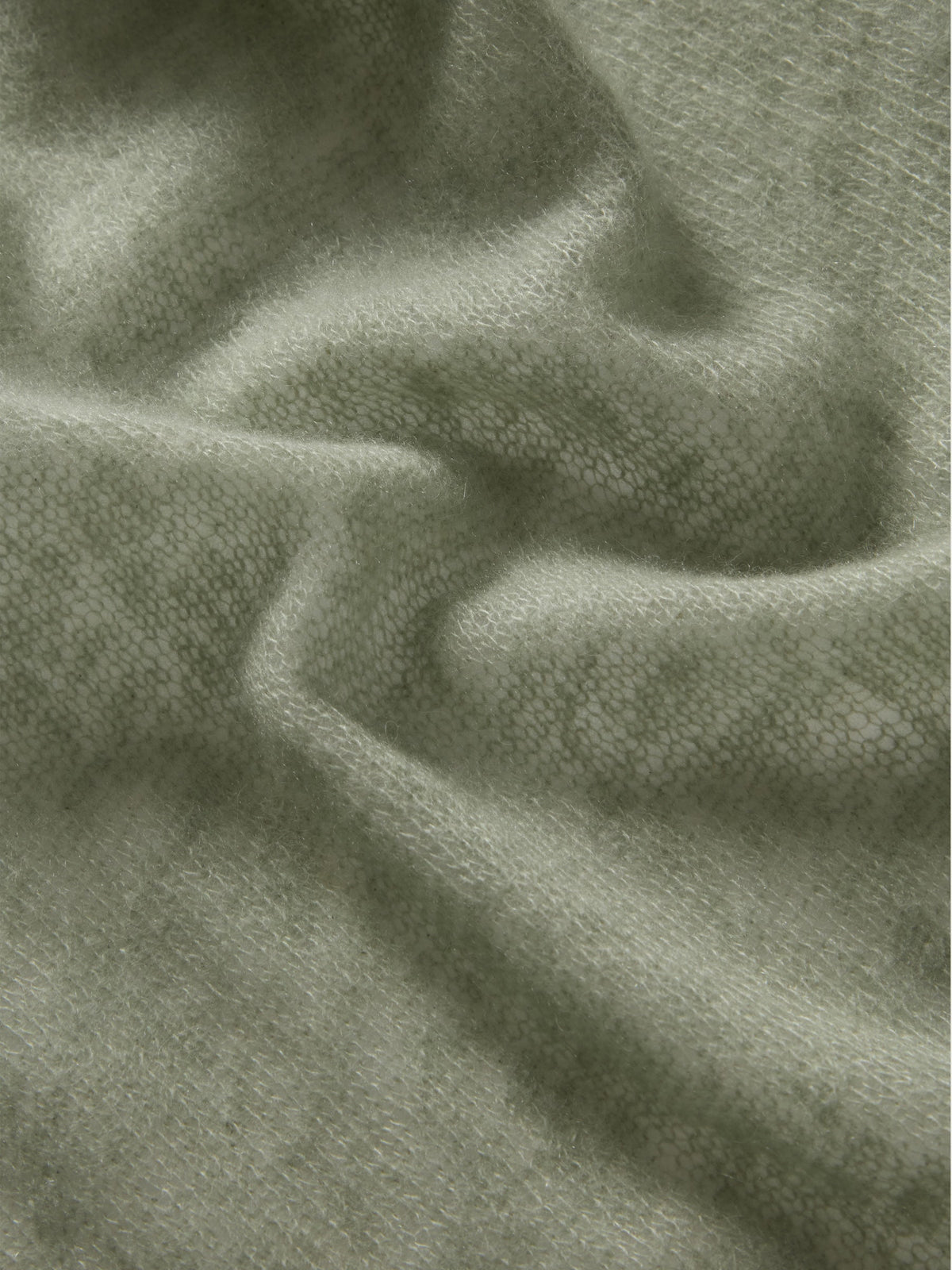 Featherlight, soft sage green We Norwegians Monogram Cashmere Scarf with an all-over repeating monogram pattern.