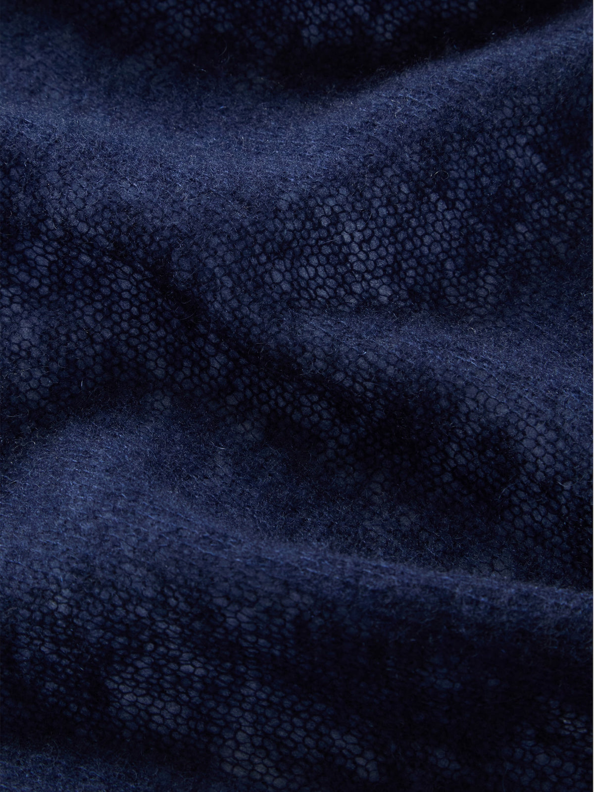 We Norwegians Monogram Cashmere Scarf in featherlight dark navy blue with an all-over repeating monogram pattern.