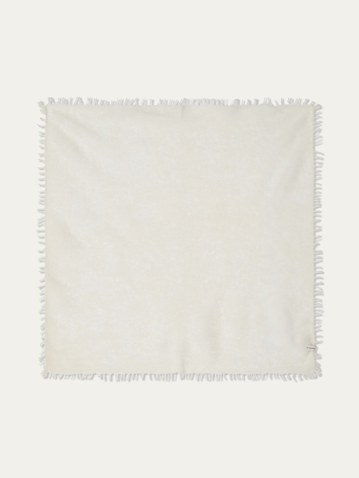 Square, featherlight off-white Monogram Cashmere Scarf by We Norwegians with a fringed border.