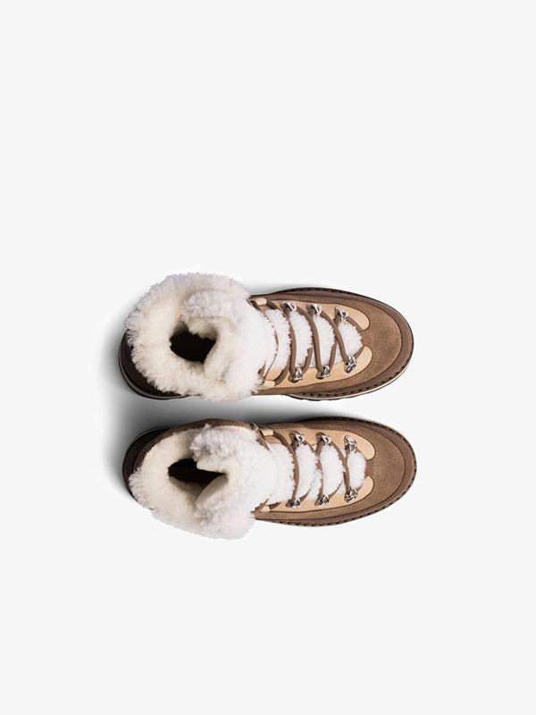 Top view of a pair of brown Mono X We Norwegians Tag Cap hiking boots, crafted from premium Italian materials with white laces and cozy shearling lining, set against a pristine white background.