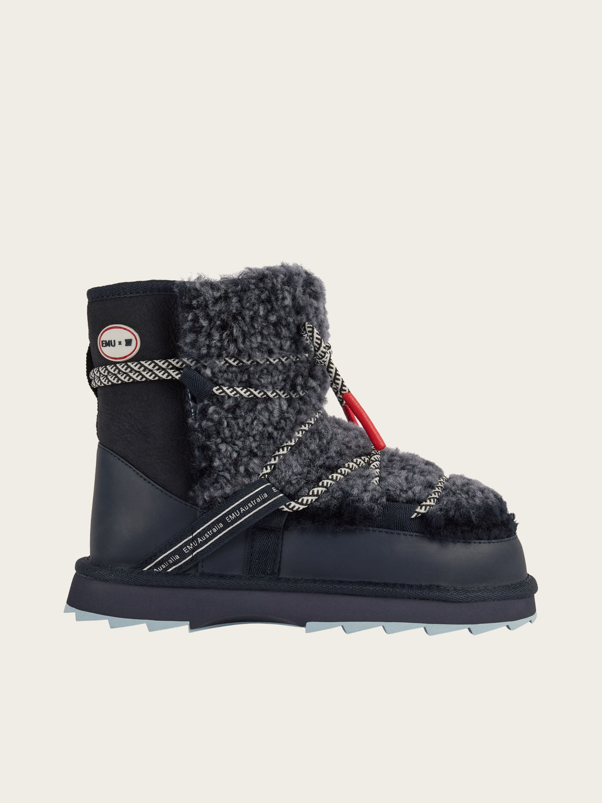 A single EMU x WN Blurred Teddy boot by EMU, featuring thick gray Australian sheepskin shearling, rope laces, a red accent, a textured sole, and a small logo patch on the ankle in black, is displayed on a plain light background.