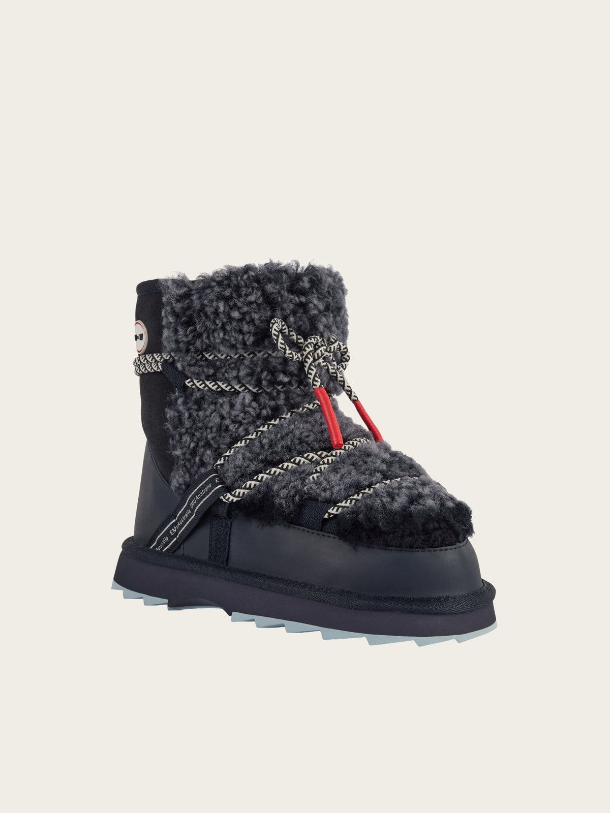 The EMU x WN Blurred Teddy, a black winter boot by EMU, features gray faux fur trim, decorative rope laces with red accents, a thick sole, and textured stitching inspired by Nordic design, displayed against a plain light background.