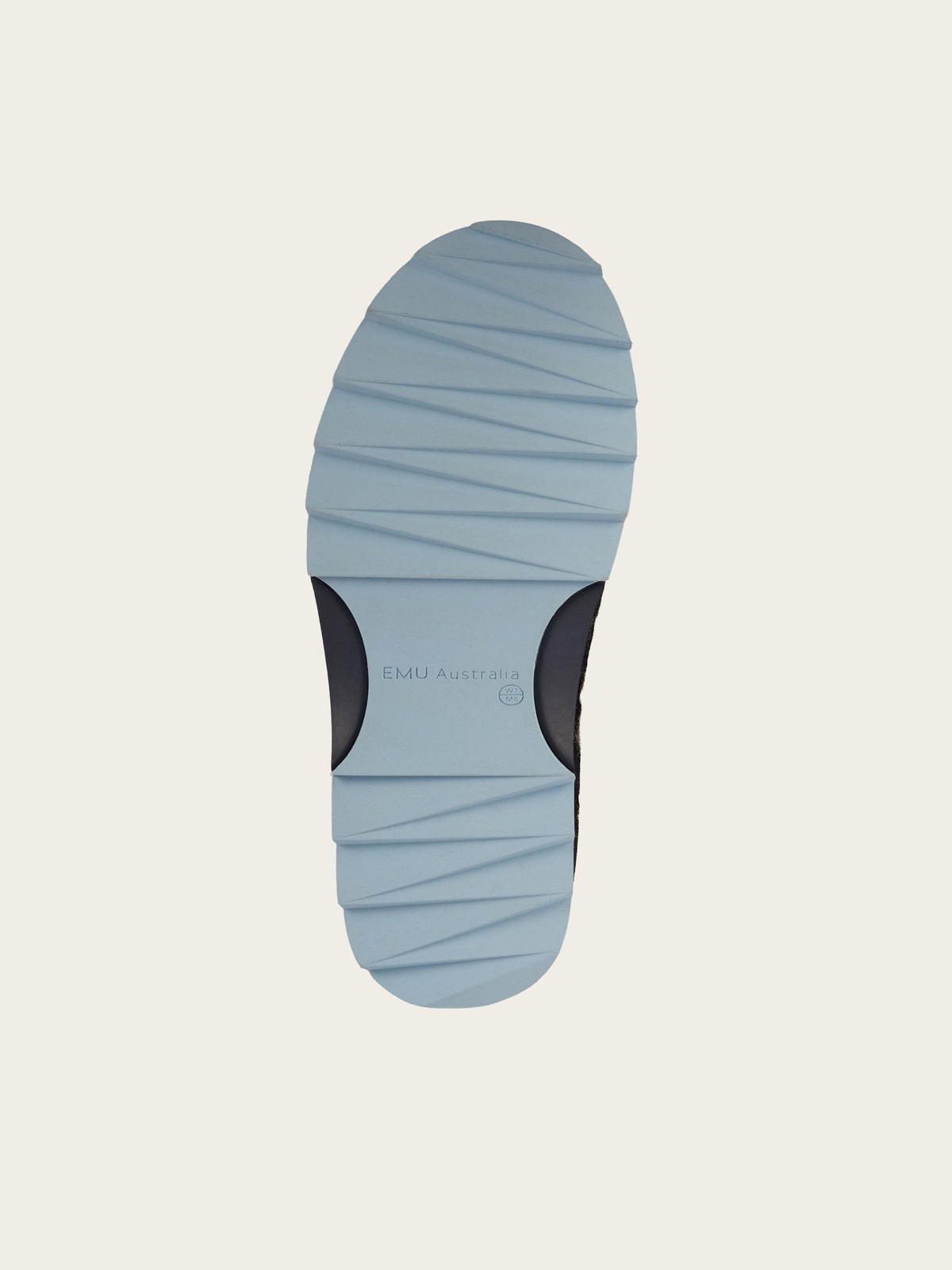 Light blue shoe sole with horizontal grooves and “EMU Australia” text in the center, designed for the EMU x WN Sharky Lo Teddy sheepskin boots by We Norwegians. The heel area features two black patches for added grip on the durable rubber sole. The background is off-white.
